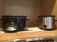 Black Rival slow cooker with control knob showing power, cook time, high, low, and warm settings