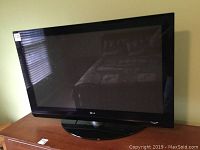 Front view of LG plasma TV sitting on the swivel base, showing screen and bezel with LG logo.