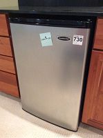 Closed view of stainless steel Franklin Chef refrigerator under counter with a sticker showing dimensions 22x22x32 inches.