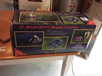 Box of U-Boat 2000 Super Combo showing the product name and illustrations of use on water, emphasizing fishing with the inflatable float tube.