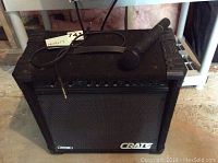 Front view of Crate GX-60 amplifier with microphone on top, showing grille and control panel