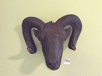 Front view of ceramic ram head wall mount showing full face and horns.