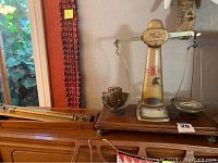 Wide view of the vintage Pooley scale and wooden architect ruler on wooden furniture.