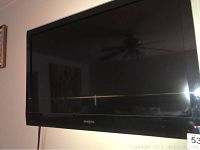 Front view of Insignia 36 inch flat screen TV showing screen and reflection