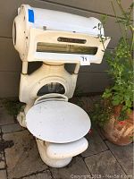 Full front view of the weathered white enamel TOLEDO meat scale, showing the weighing platform and front panel.