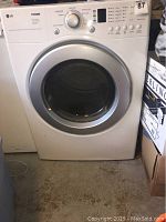 Front view of LG Tromm dryer showing control panel and door.