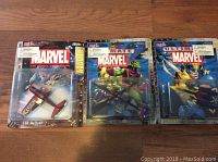 Lot of three Marvel-themed die-cast airplanes in original packaging with visible wear