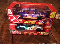 Photo showing both die cast cars in their original boxed packaging: the 1996 Kmart Little Caesars #37 car and the 2002 Zerex #10 car by Racing Champions.