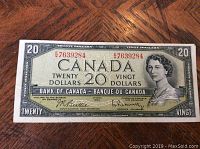 Front view of the 1954 Canadian twenty dollar bill featuring Queen Elizabeth II, serial number EW7639284, and signatures.