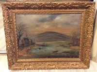 Front view of the framed oil painting depicting a lakeside landscape with houses, boats, and hills.