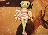 Betty Boop plush toy in pink satin dress, with tag attached displaying Betty Boop logo and branding.