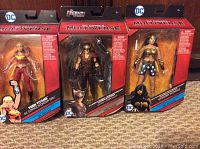 Photo of three DC Comics Multiverse action figures new in box: Wonder Woman, King Shark, and Dr Psycho, displaying front of packaging.