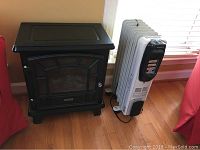 Wide view of Duraflame heater and white HomeBasix oil-filled heater on wood floor