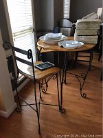 Full view of bistro table and one chair showing materials and design details