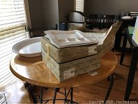 Turkey platter on table with stacked boxed grill plates and chip and dip platter on top