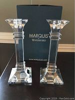 Pair of Marquis by Waterford crystal candlesticks with original box in background, showing square bases and flared tops.