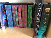 Close-up of Harry Potter boxed set and other boxed collections on shelf showing spines and titles