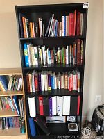 Front view of the bookcase filled with books and binders (contents not included).