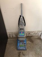 Full view of the Hoover SteamVac carpet steamer upright unit showing handle, tanks and base.