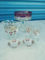 Complete 5 piece Northwood glassware set with candy dish on a marble surface in front of a blue backdrop.