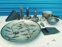 Full view of all items laid out on a table in front of a blue shutter door