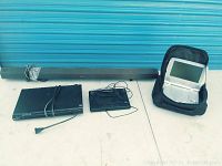 Photo showing Sony DVD player, Sony sound bar, and Mintek portable DVD player with accessories on floor.