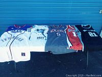 Photo showing all 6 jerseys laid out flat, visible front designs, colors, and numbers