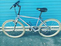 Full side view of the 26 inch Specialized Rockhopper mountain bike showing overall frame, tires, seat, and handlebars.
