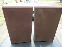 Pair of BOZAK LS-200A stereo speakers with brown fabric front covers and laminate wood cases.