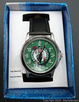 Front view of men's wrist watch with black leather band and green Boston Celtics dial inside original packaging.