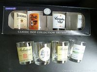 4 new whiskey glasses in original Luminarc Classic DOF Collection box with four different printed whiskey brand logos visible through box window.