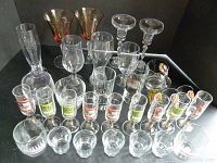 Wide view of all glassware showing vodka, sherry, champagne, shot, reunion, Licca, and Hamm's glasses.