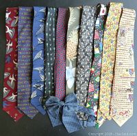 Lot of 10 assorted vintage neckties arranged side by side showing various prints and colors including The Beatles theme, birds, fruit, flags, and text designs.