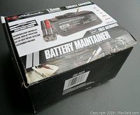 Schumacher SEM-1562A battery maintainer and trickle charger box showing branding and features