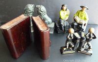 Photo showing all four pairs of bookends including wooden books, pottery lions, Japanese basketball players, and Asian figurines