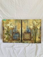 Photo of two floral art paintings side by side on white backdrop, showing white lilies and abstract square patterns on textured multicolored background.
