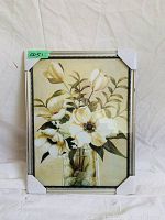 Frontal photo of a rectangular framed floral art print, still in white protective corner packaging.
