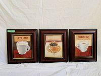 Three framed coffee art prints displayed side by side on a white fabric background.
