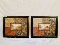 Two framed art pieces featuring a nature scene with flying birds, both framed in dark wood frames, shown together on a white backdrop.