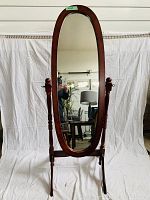 Full-length view of the adjustable stand up oval mirror showcasing the wooden frame and its supporting structure.