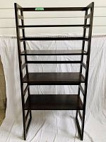 Front view of dark brown shelf display unit with six shelves against white background