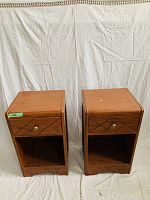 Set of two wooden night tables side by side with drawer closed
