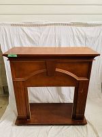 Full front view of the wooden mantel showing overall design and condition.