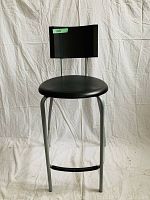 Front view of the black chair/stool showing the round seat, rectangular backrest, and metal frame with footrest.