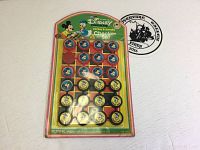 Photo of vintage 1970s Disney checker set featuring Mickey Mouse and Donald Duck on original cardboard backing sealed in plastic packaging.