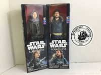 Two unopened Star Wars Rogue One action figures: Jyn Erso and Cassian Andor, displayed side by side in original packaging.