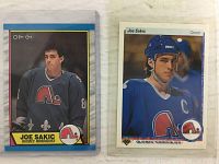 Front view of Joe Sakic OPC rookie card in Quebec Nordiques jersey and 2nd year Upper Deck card in blue jersey with helmet