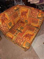 Chair angled to show cushion pattern and bamboo frame