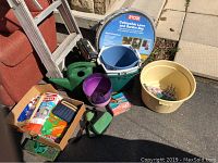 Aluminum ladder, Ryobi collapsible lawn and garden bag, watering can, purple pot, yellow plastic bucket, gardening gloves, bags, assorted tools