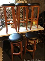 Five stools arranged on table, front view